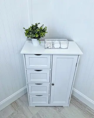 a white table with a plant on top of it at Cozy House