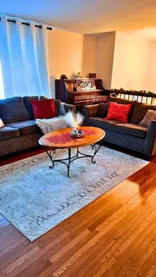 a living room with a couch and a coffee table at Cozy House