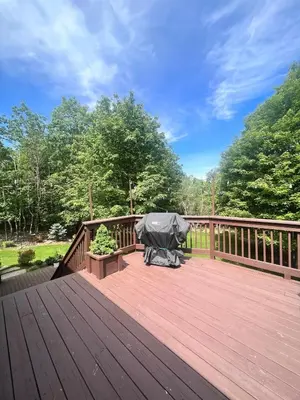 a large wooden deck with a cover on it at Cozy House