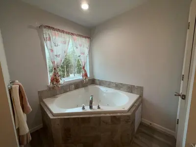 a bath tub in a bathroom with a window at Pocono Escape - Modern & Cozy in Pocono Summit