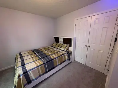 a small bedroom with a bed and a closet at Pocono Escape - Modern & Cozy in Pocono Summit