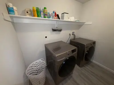 a laundry room with a washing machine and a shelf at Pocono Escape - Modern & Cozy in Pocono Summit
