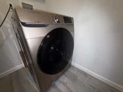 a washing machine in a corner of a room at Pocono Escape - Modern & Cozy in Pocono Summit