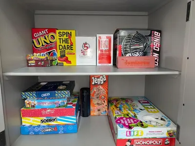 a book shelf filled with lots of snacks and games at Pocono Escape - Modern & Cozy in Pocono Summit