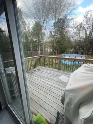 a view of a deck from a sliding glass door at Pocono Escape - Modern & Cozy in Pocono Summit