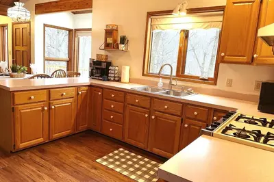a kitchen with wooden cabinets and a sink at Forest View in Paradise