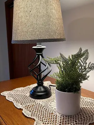 a lamp sitting on a table next to a potted plant at Forest View in Paradise