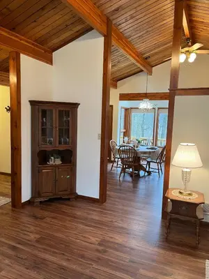 a living room with a table and a dining room at Forest View in Paradise