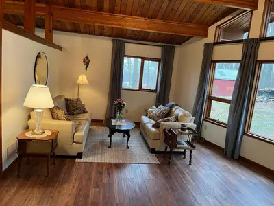a living room with a couch and a table at Forest View in Paradise