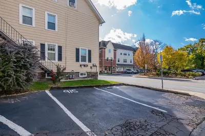 an empty parking lot in front of a house at NEW - Mainline Train, Colleges, Hospital in Bryn Mawr