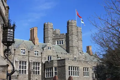an old castle with a flag on top of it at NEW - Mainline Train, Colleges, Hospital in Bryn Mawr