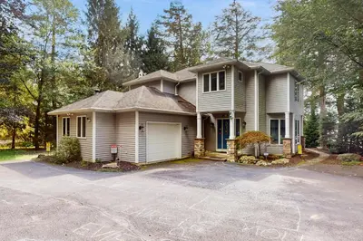 a white house with a driveway in front of it at Beach and Dock! Group-Friendly Albrightsville Gem in Towamensing Trails