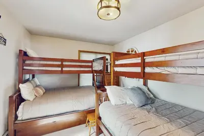 a bedroom with two bunk beds and a couch at Beach and Dock! Group-Friendly Albrightsville Gem in Towamensing Trails