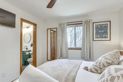 a white bedroom with a bed and a window at Pocono Mountain Family Home with Deck and Grill in Saw Creek