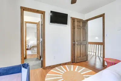 a living room with a bed and a mirror at Pocono Mountain Family Home with Deck and Grill in Saw Creek