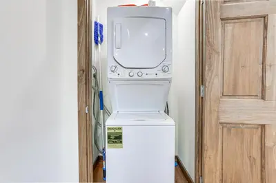 a washer and dryer sitting on top of a refrigerator at Pocono Mountain Family Home with Deck and Grill in Saw Creek