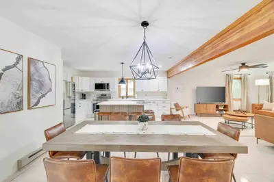 a kitchen and dining room with a table and chairs at Woodlands Hideaway- Hot Tub Grill & Games in Albrightsville