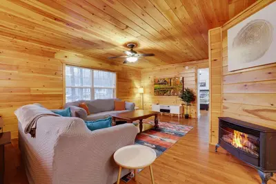 a living room with a couch and a fireplace at Cozy Freeland Retreat- Firepit Pool Table Hot Tub in White Haven