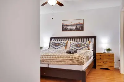 a bedroom with a bed and a night stand at Cozy Freeland Retreat- Firepit Pool Table Hot Tub in White Haven