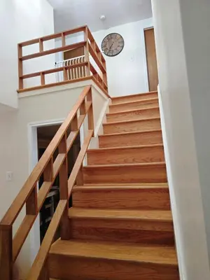 a staircase in a house with a clock on the wall at Bridle Pool House in Lansdale