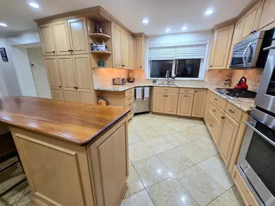 a large kitchen with wooden cabinets and a counter top at Bridle Pool House in Lansdale