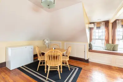 a dining room with a table and chairs at Quaint 3rd Floor Loft in Highland Park