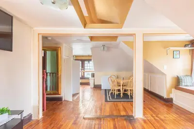 a dining room and living room with a table at Quaint 3rd Floor Loft in Highland Park