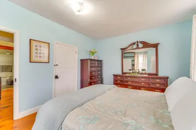 a bedroom with a bed and a dresser and a mirror at 3 Mi to Penns Creek Access Hideaway with Grill! in Millmont
