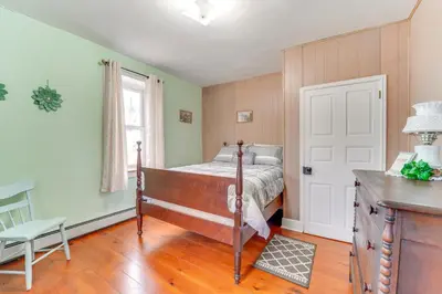 a bedroom with a bed and a table and a window at 3 Mi to Penns Creek Access Hideaway with Grill! in Millmont