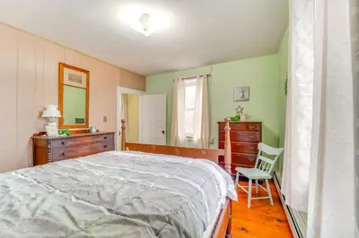 a bedroom with a bed and a dresser and a chair at 3 Mi to Penns Creek Access Hideaway with Grill! in Millmont