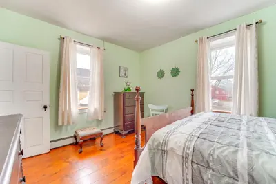 a bedroom with green walls and a bed and a window at 3 Mi to Penns Creek Access Hideaway with Grill! in Millmont