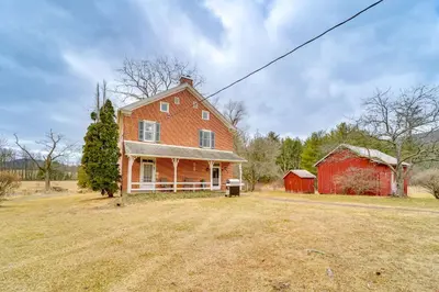 a large red house and a red barn at 3 Mi to Penns Creek Access Hideaway with Grill! in Millmont