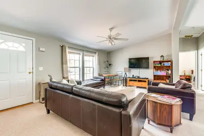 a living room with leather furniture and a ceiling fan at Family Home in Arrowhead Lake with Fire Pit! in Pocono Lake