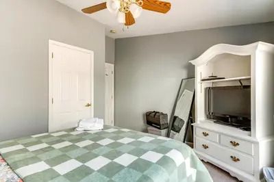 a bedroom with a bed and a flat screen tv at Family Home in Arrowhead Lake with Fire Pit! in Pocono Lake