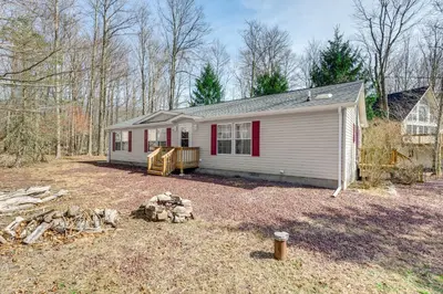 a small white house with red trim in a yard at Family Home in Arrowhead Lake with Fire Pit! in Pocono Lake