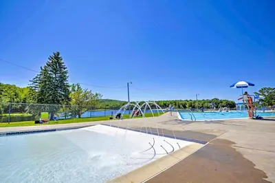 a pool with a water park with a water slide at Family Home in Arrowhead Lake with Fire Pit! in Pocono Lake
