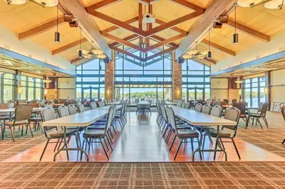 a dining hall with tables and chairs and windows at Family Home in Arrowhead Lake with Fire Pit! in Pocono Lake