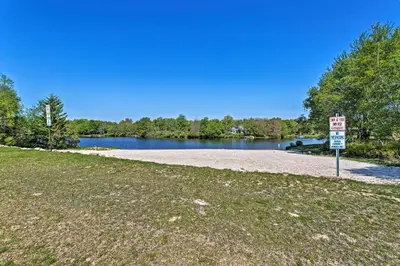 a no parking sign in front of a lake at Fire Pit and Game Room Spacious Poconos Retreat! in Long Pond