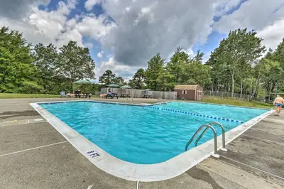 a large blue swimming pool in a parking lot at Fire Pit and Game Room Spacious Poconos Retreat! in Long Pond