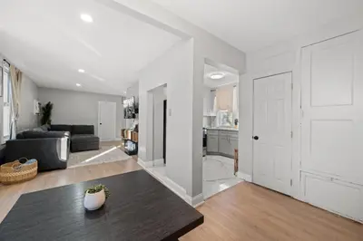 a living room with a couch and a table at The City Spacious Stay Near EWR And NYC Mins to Train in Bayonne