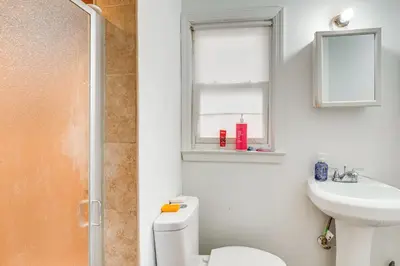 a bathroom with a toilet and a sink and a window at Work, Explore and Relax Centrally Located Union Gem in Union