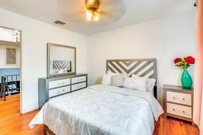 a bedroom with a bed and a vase of flowers at Work, Explore and Relax Centrally Located Union Gem in Union