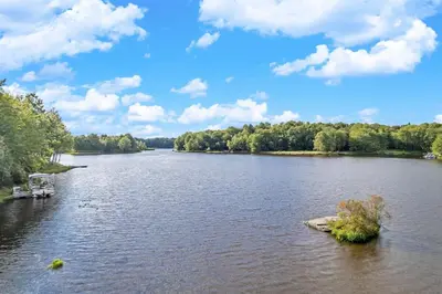 a view of a river with a boat in it at Lakefront Sunset Horizon in Locust Lakes Village