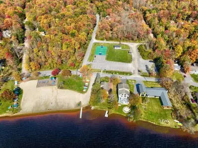 an aerial view of a large estate on a lake at Lakefront Sunset Horizon in Locust Lakes Village