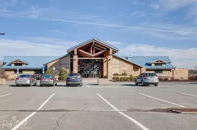 a parking lot with cars parked in front of a building at Lakefront Sunset Horizon in Locust Lakes Village