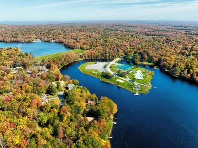 an aerial view of a house on an island in a lake at Lakefront Sunset Horizon in Locust Lakes Village