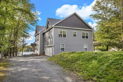 a large house with a driveway in front of it at Lakefront Sunset Horizon in Locust Lakes Village