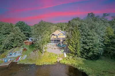 an aerial view of a house on a river at Lakefront Sunset Horizon in Locust Lakes Village