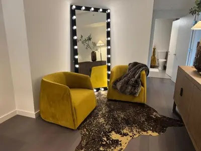 a living room with two chairs and a mirror at NEWLuxe 2bd2ba w Pool & More in Hoboken