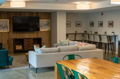 a living room with a couch and a table at NEWLuxe 2bd2ba w Pool & More in Hoboken